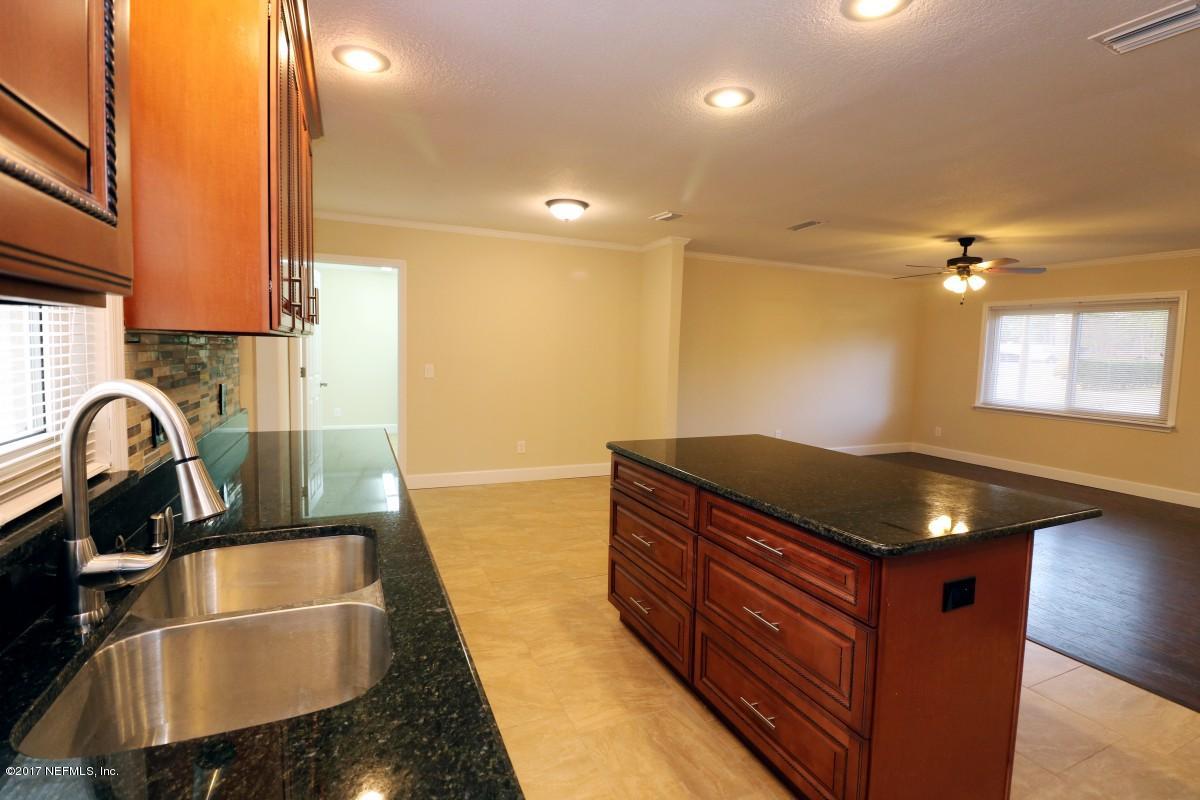 8584 Old Plank Road Jacksonville, FL 32220 - Photo 16 of 23 a kitchen with granite countertop a stove and a sink