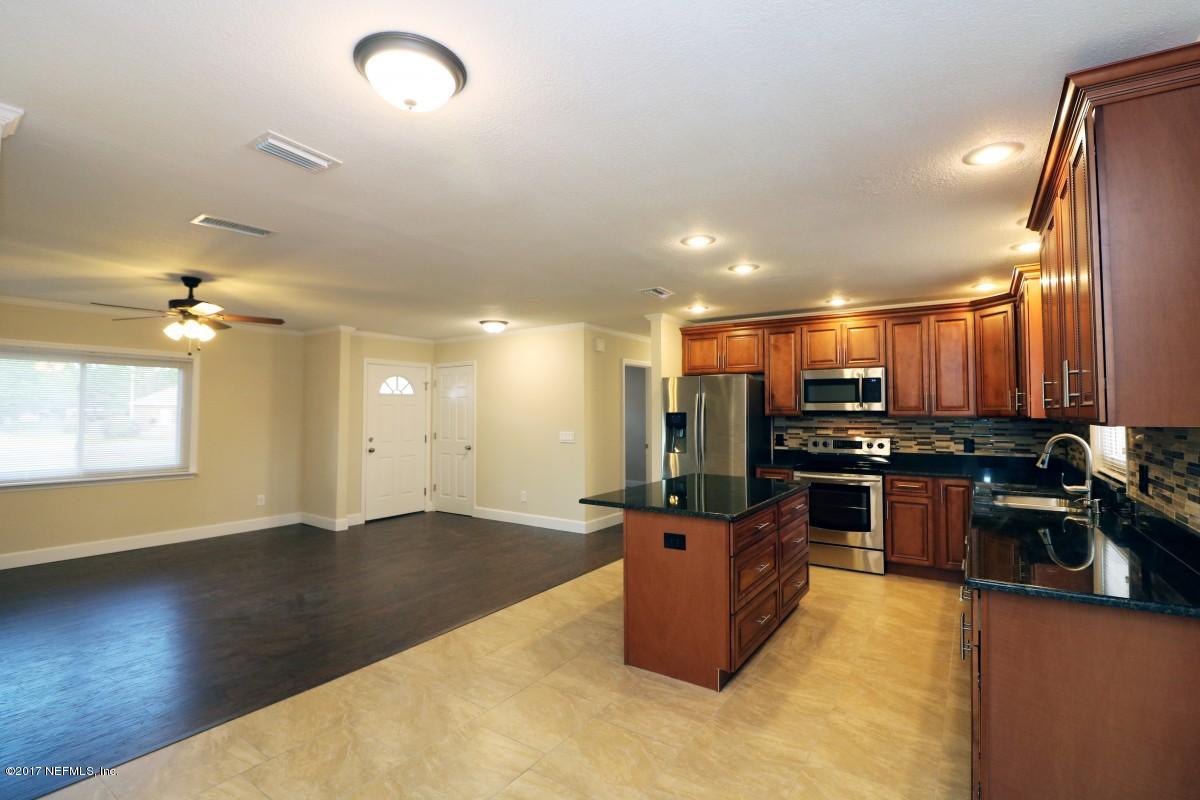 8584 Old Plank Road Jacksonville, FL 32220 - Photo 17 of 23 a kitchen with stainless steel appliances granite countertop a stove top oven and sink