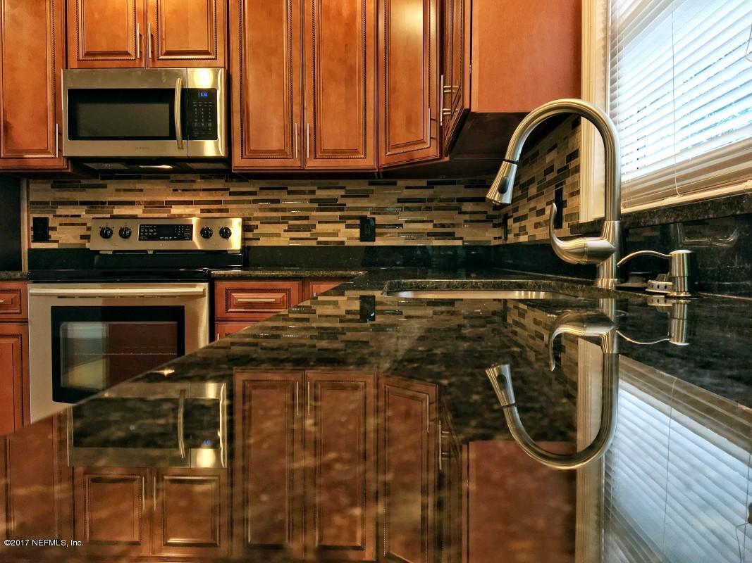 8584 Old Plank Road Jacksonville, FL 32220 - Photo 18 of 23 a kitchen with a stove and a microwave