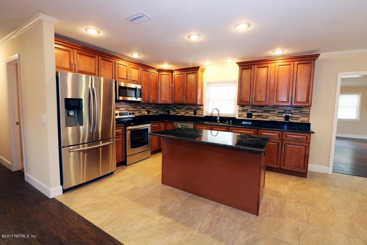 8584 Old Plank Road Jacksonville, FL 32220 - Photo 20 of 23 a kitchen with stainless steel appliances granite countertop a stove a sink and a refrigerator