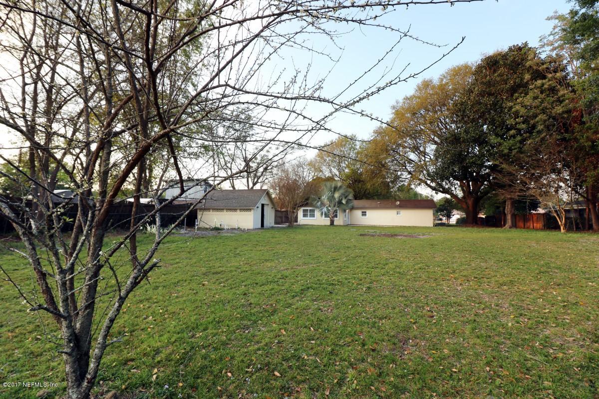 8584 Old Plank Road Jacksonville, FL 32220 - Photo 3 of 23 a view of outdoor space with deck and trees