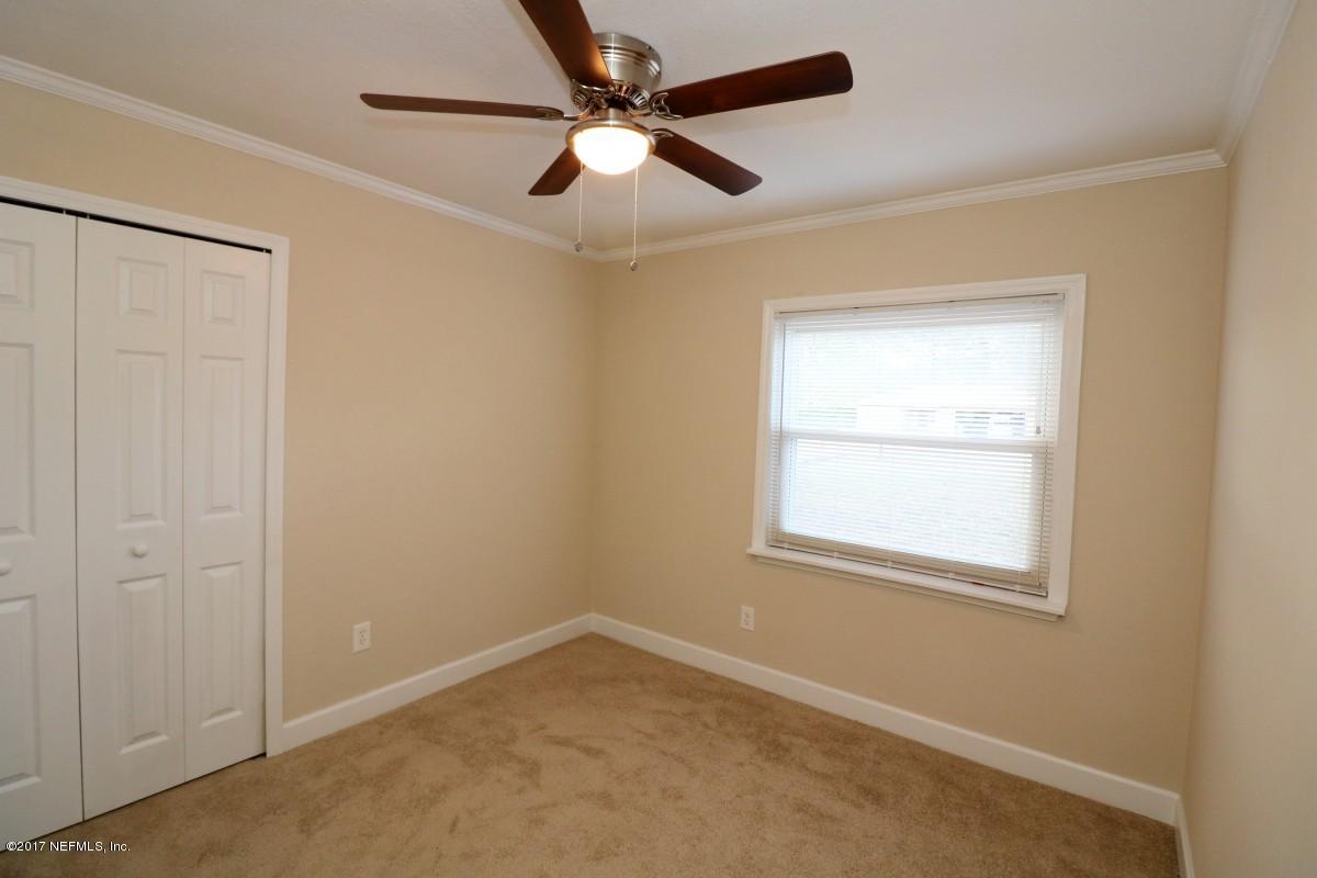 8584 Old Plank Road Jacksonville, FL 32220 - Photo 9 of 23 an empty room with a window and a fan
