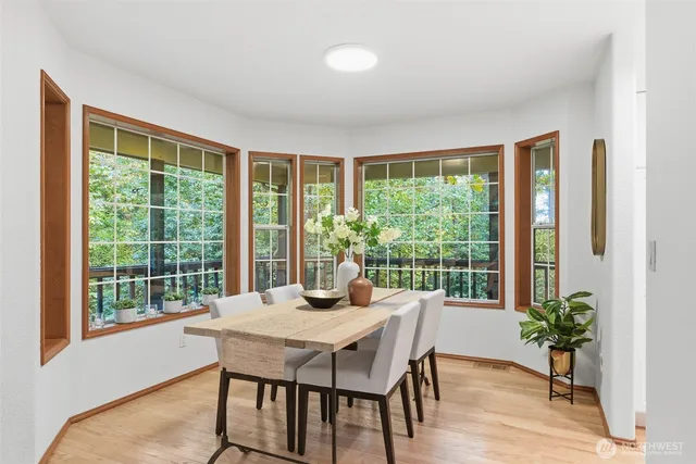 a view of a dining room with furniture window and wooden floor