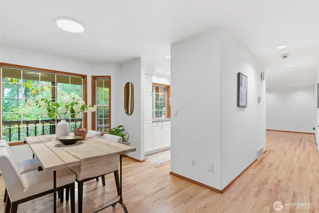 a view of a living room and kitchen with wooden floor
