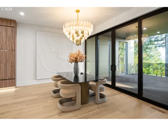 a dining room with furniture a chandelier and wooden floor