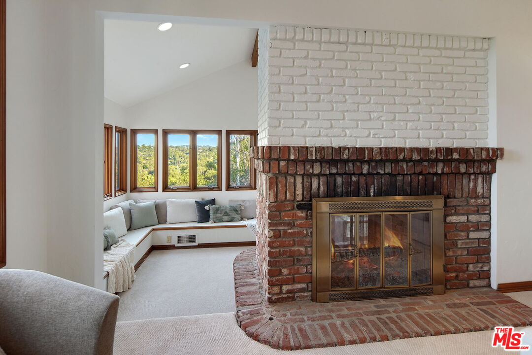 16814 Oak View Drive Encino, CA 91436 - Photo 13 of 49 a living room with furniture and a fireplace