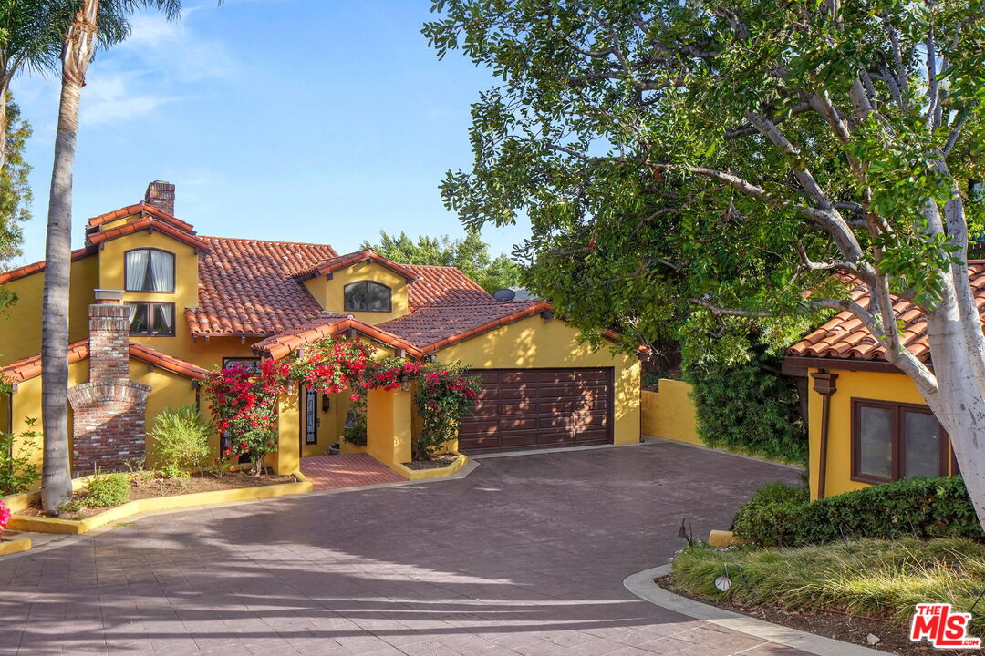 16814 Oak View Drive Encino, CA 91436 - Photo 2 of 49 a front view of a house with a yard and garage
