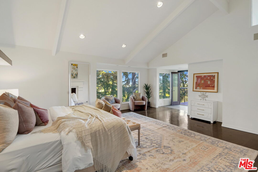 16814 Oak View Drive Encino, CA 91436 - Photo 23 of 49 a bed room with a bed and a couch