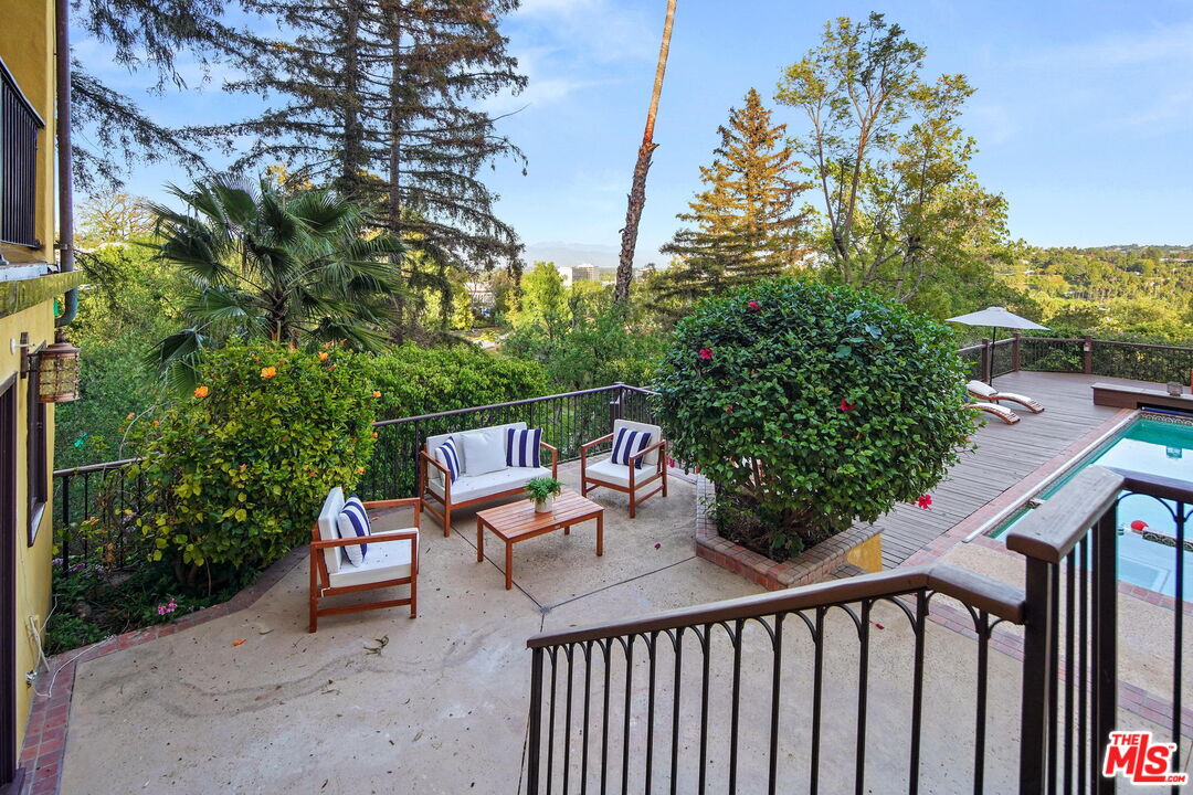 16814 Oak View Drive Encino, CA 91436 - Photo 39 of 49 a balcony with wooden floor and outdoor seating