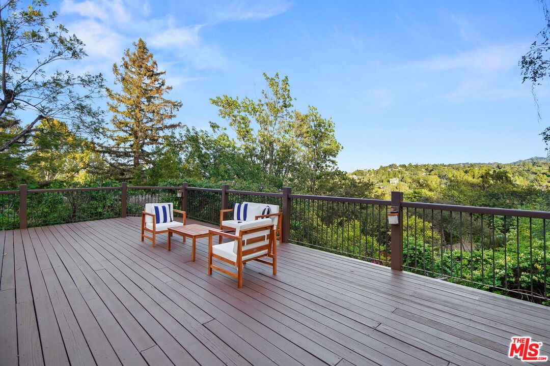 16814 Oak View Drive Encino, CA 91436 - Photo 41 of 49 a roof deck with table and chairs and wooden floor