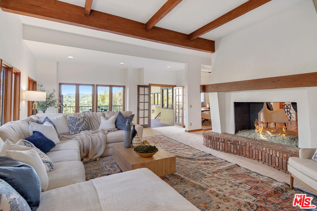 16814 Oak View Drive Encino, CA 91436 - Photo 8 of 49 a living room with furniture fireplace and flat screen tv