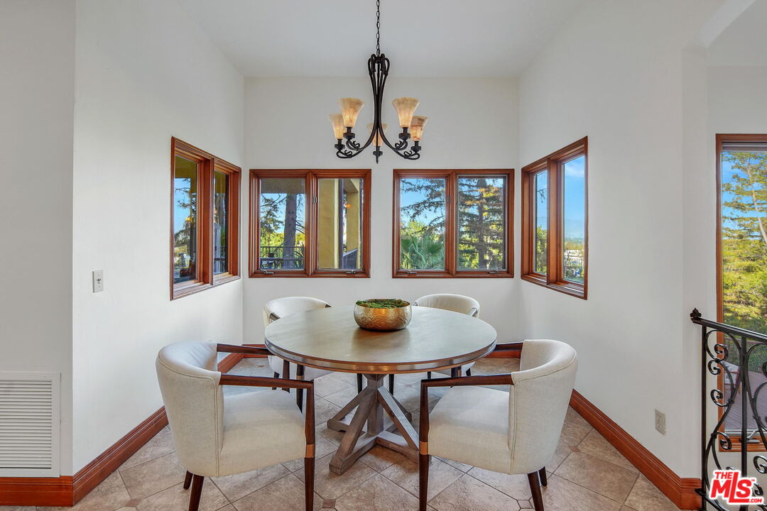 16814 Oak View Drive Encino, CA 91436 - Photo 10 of 49 a view of a dining room with furniture window and wooden floor