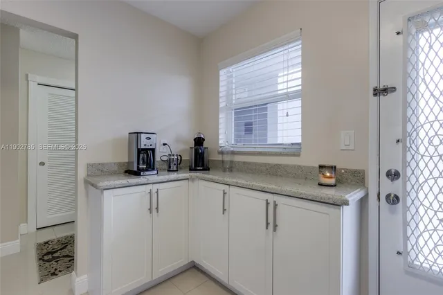 a kitchen with white cabinets and a sink