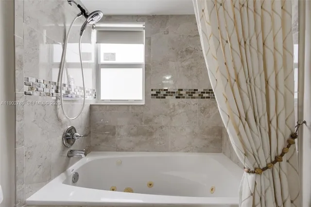 a bath tub sitting next to a shower