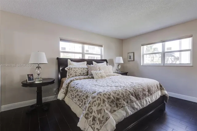 a bed sitting in a bedroom next to a window with lamp