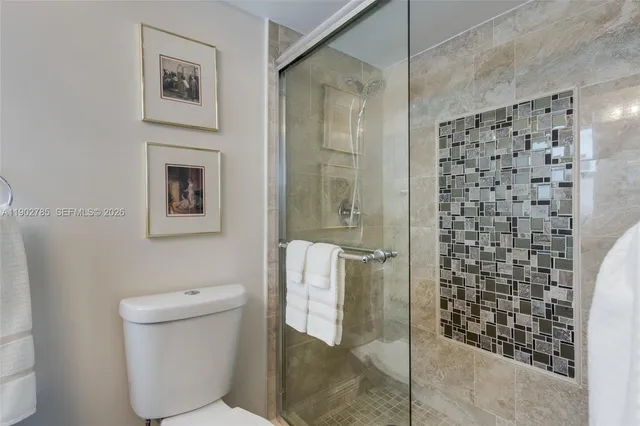 a bathroom with a shower and toilet