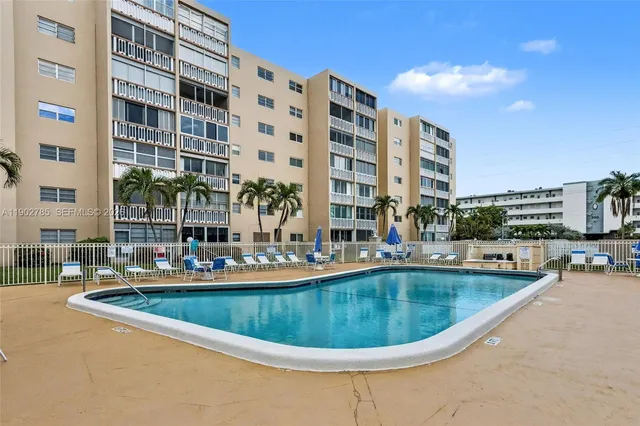 a view of a swimming pool with outdoor seating