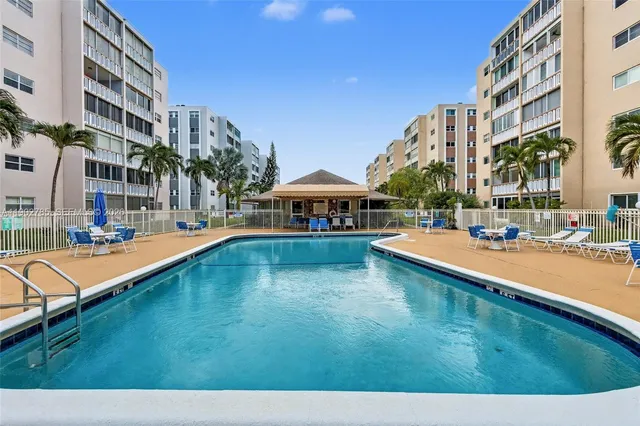 a swimming pool with outdoor view and trees