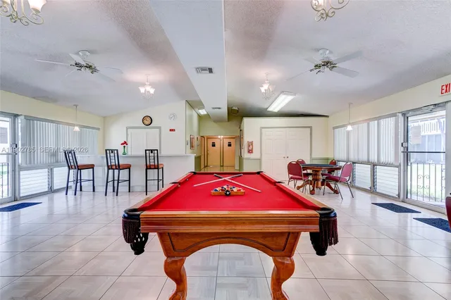 a living room with furniture and pool table
