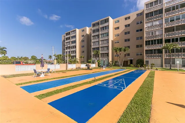 a swimming pool with outdoor seating and yard