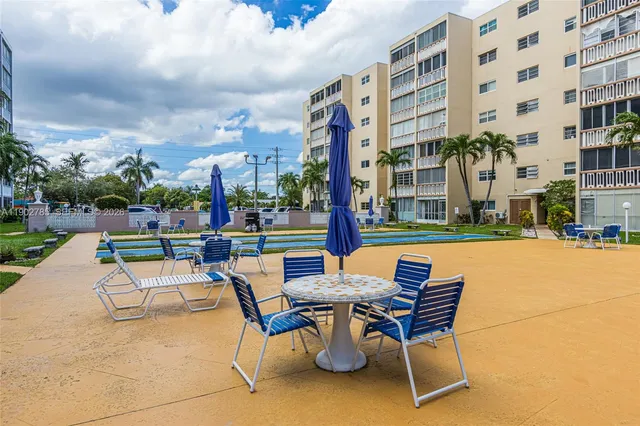 a view of a patio with a table and chairs