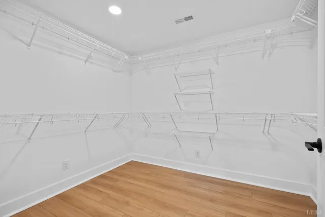 a bathroom with a granite countertop bathtub shower sink vanity and toilet