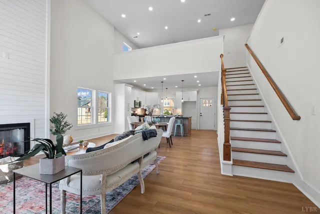 a living room with furniture wooden floor and a rug