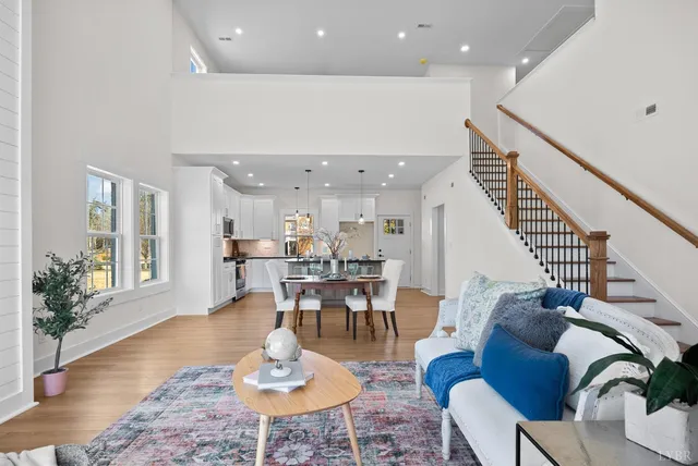 a living room with furniture a fireplace and a potted plant