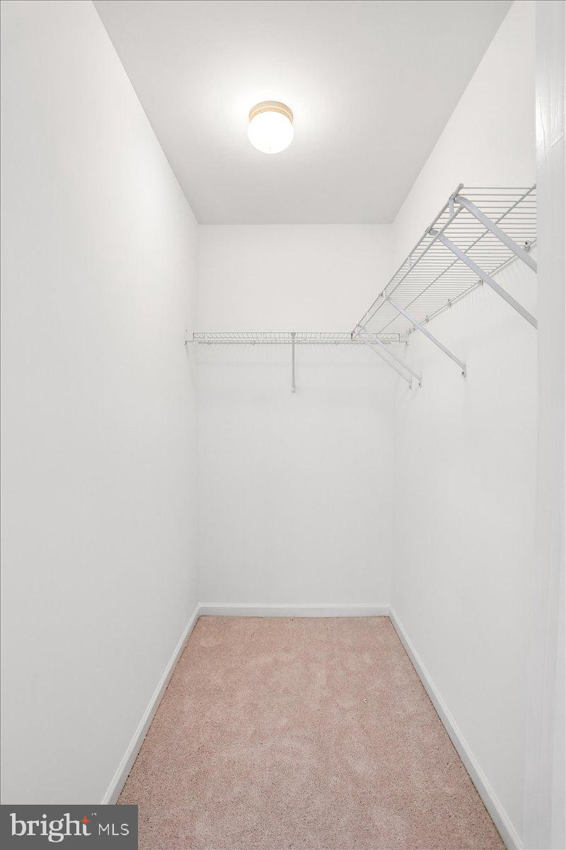 631 Constellation Square Southeast, Unit D Leesburg, VA 20175 - Photo 11 of 22 a view of a room with racks on the wall