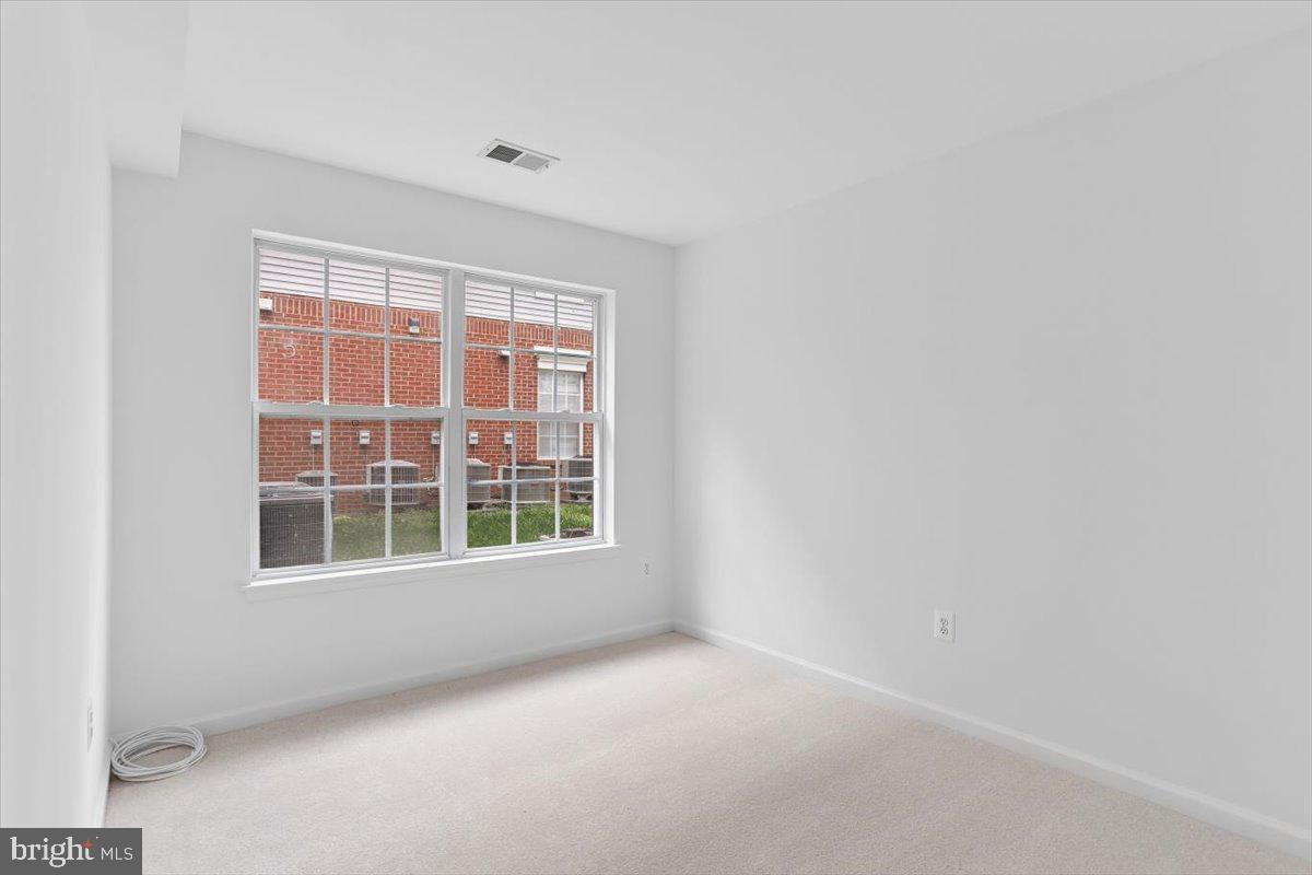 631 Constellation Square Southeast, Unit D Leesburg, VA 20175 - Photo 12 of 22 a view of an empty room with a window