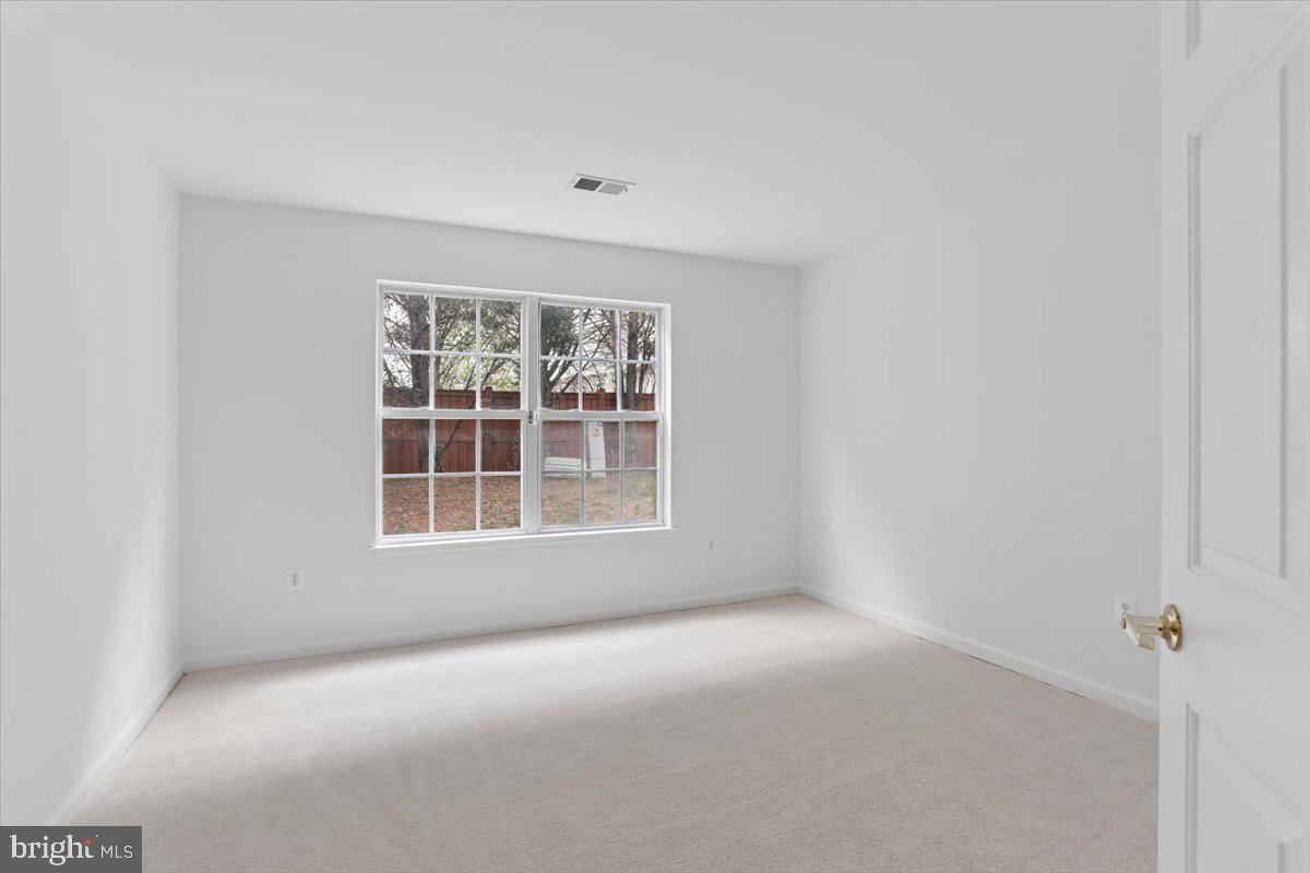 631 Constellation Square Southeast, Unit D Leesburg, VA 20175 - Photo 14 of 22 a view of an empty room with a window
