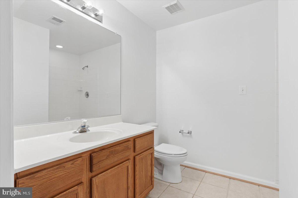 631 Constellation Square Southeast, Unit D Leesburg, VA 20175 - Photo 16 of 22 a bathroom with a sink toilet and vanity