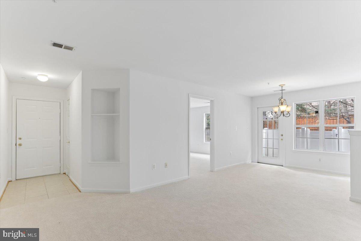 631 Constellation Square Southeast, Unit D Leesburg, VA 20175 - Photo 2 of 22 a view of an empty room with a window