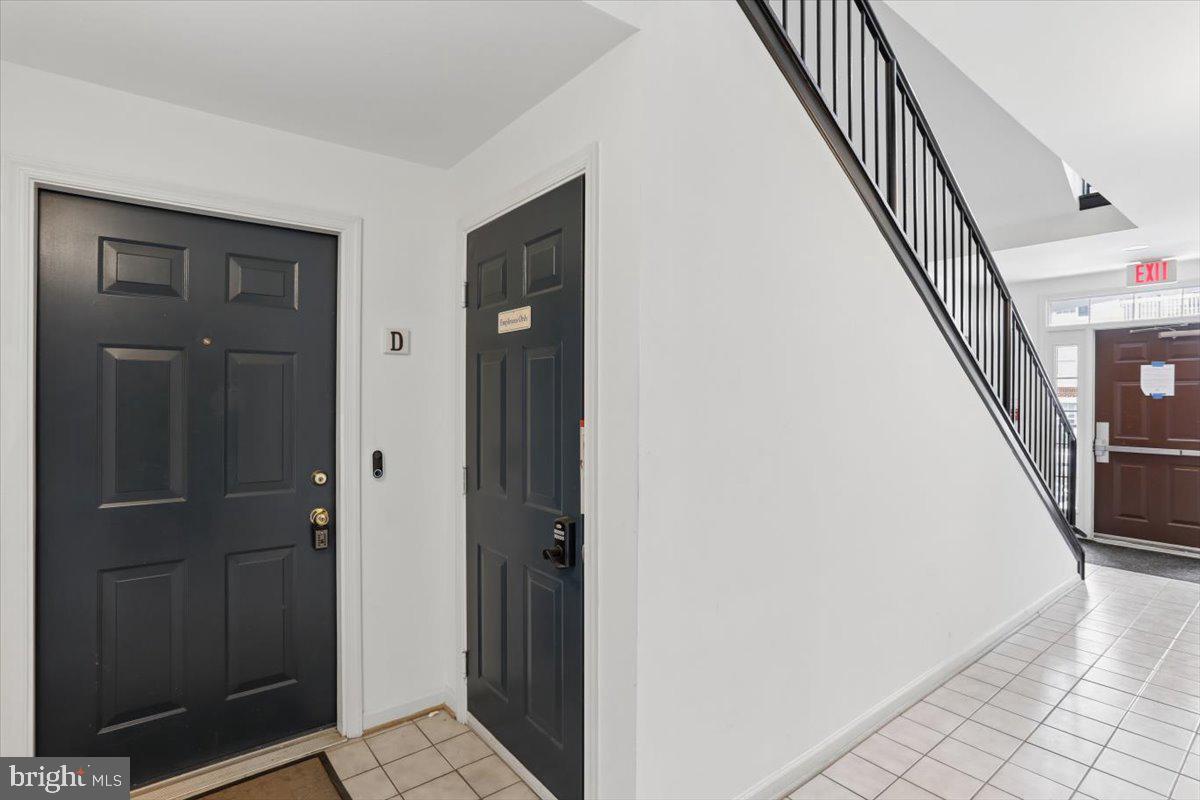 631 Constellation Square Southeast, Unit D Leesburg, VA 20175 - Photo 21 of 22 a view of a hallway with wooden floor and staircase