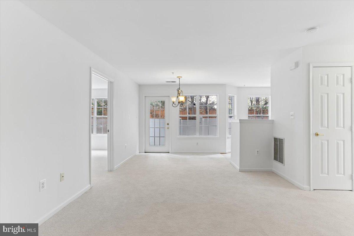 631 Constellation Square Southeast, Unit D Leesburg, VA 20175 - Photo 3 of 22 a view of empty room with floor to ceiling window
