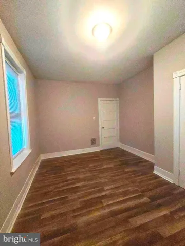 a view of room with wooden floor