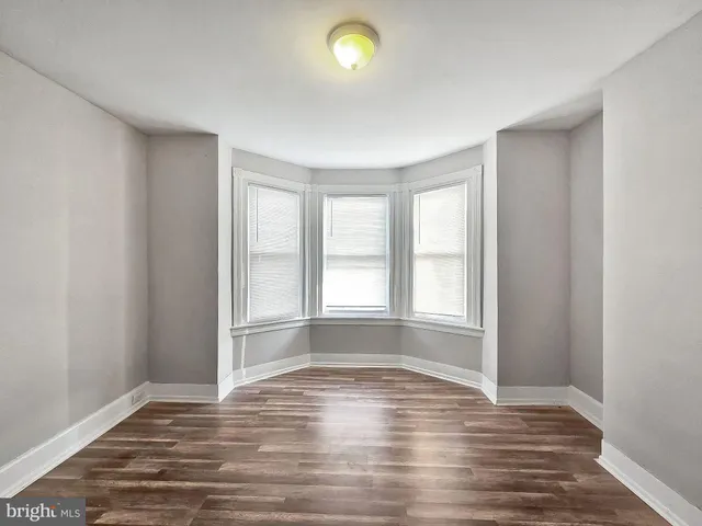 a view of an empty room and wooden floor