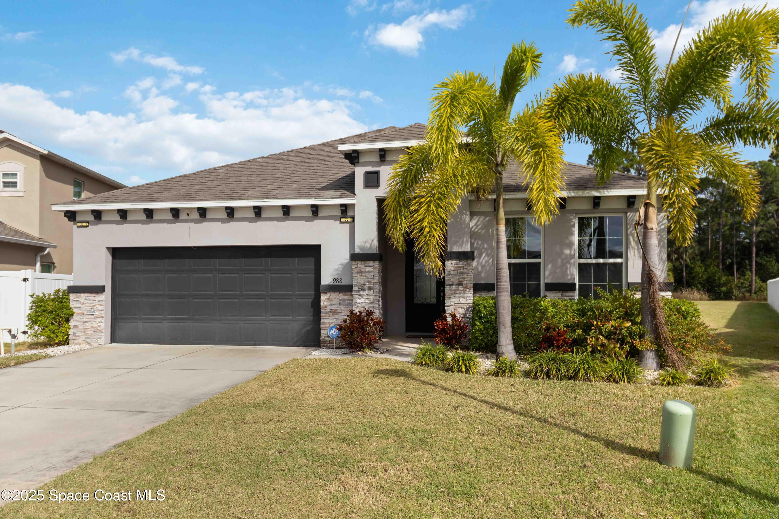 988 Corbin Circle Southwest Palm Bay, FL 32908 - Photo 1 of 26 a view of a house with palm trees