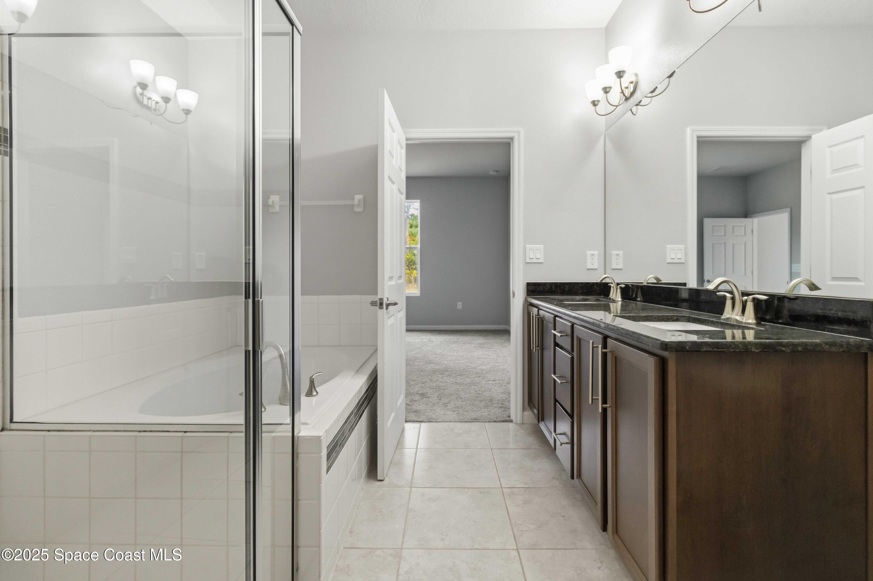 988 Corbin Circle Southwest Palm Bay, FL 32908 - Photo 13 of 26 a bathroom with a double vanity sink and a mirror