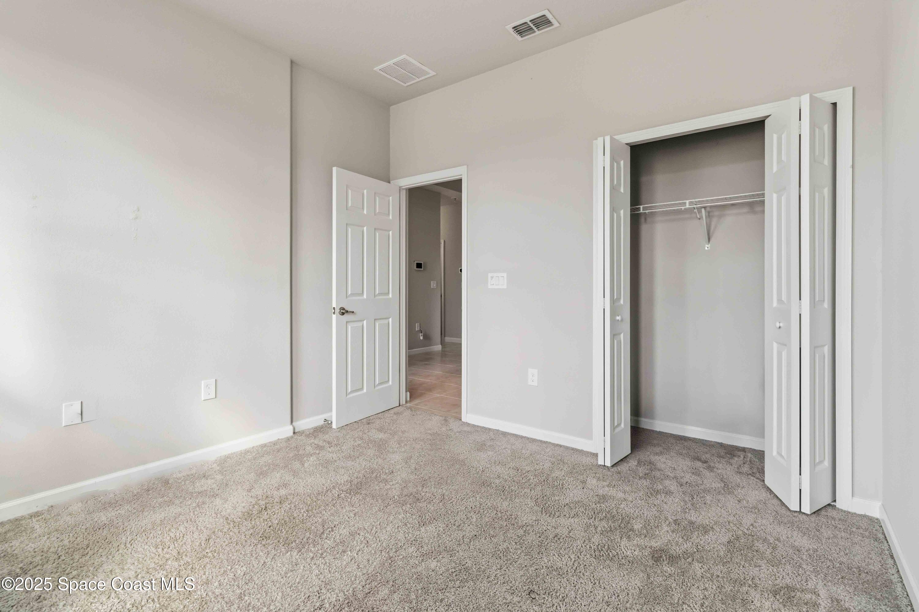 988 Corbin Circle Southwest Palm Bay, FL 32908 - Photo 16 of 26 an empty room with closet area