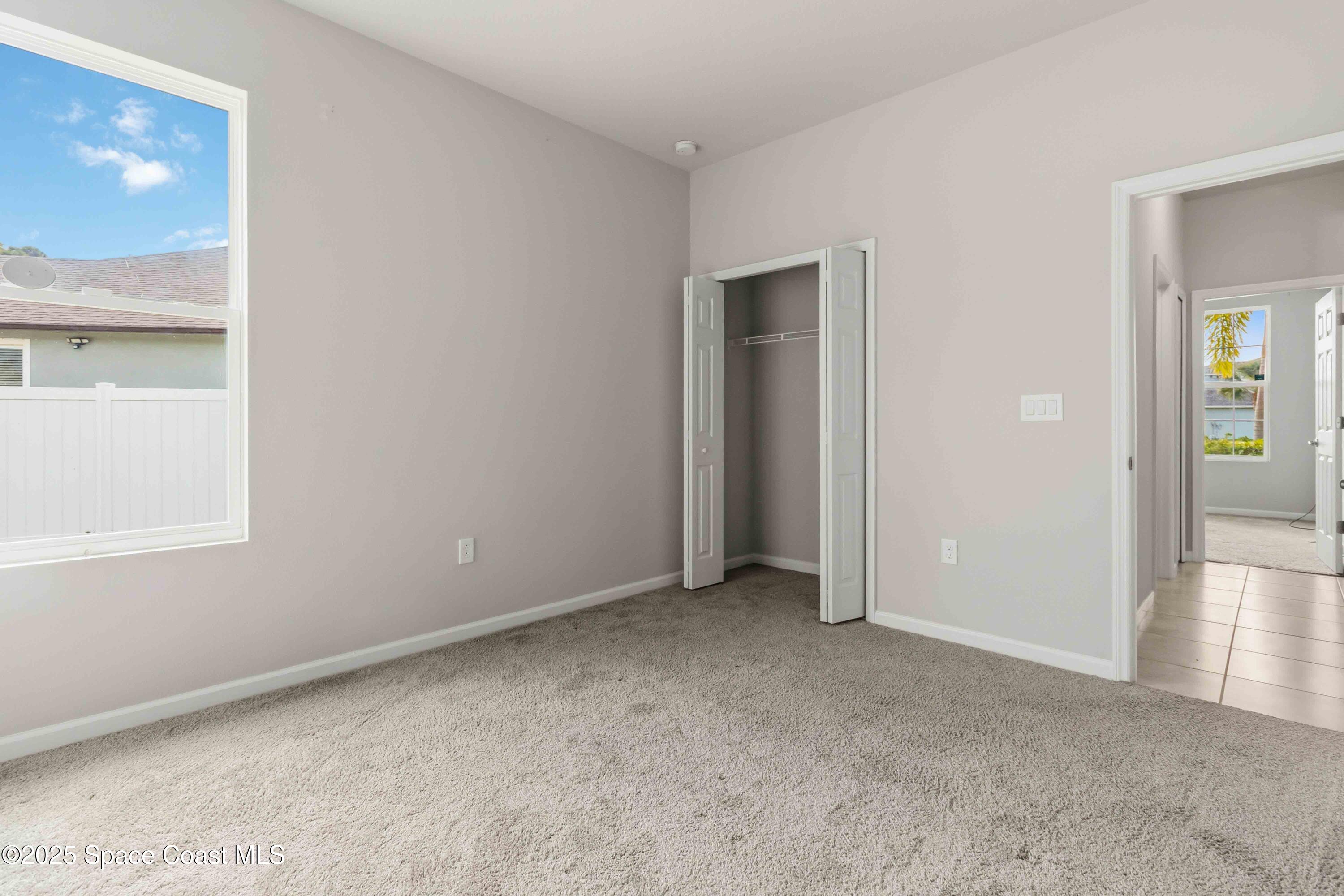 988 Corbin Circle Southwest Palm Bay, FL 32908 - Photo 17 of 26 an empty room with windows and closet