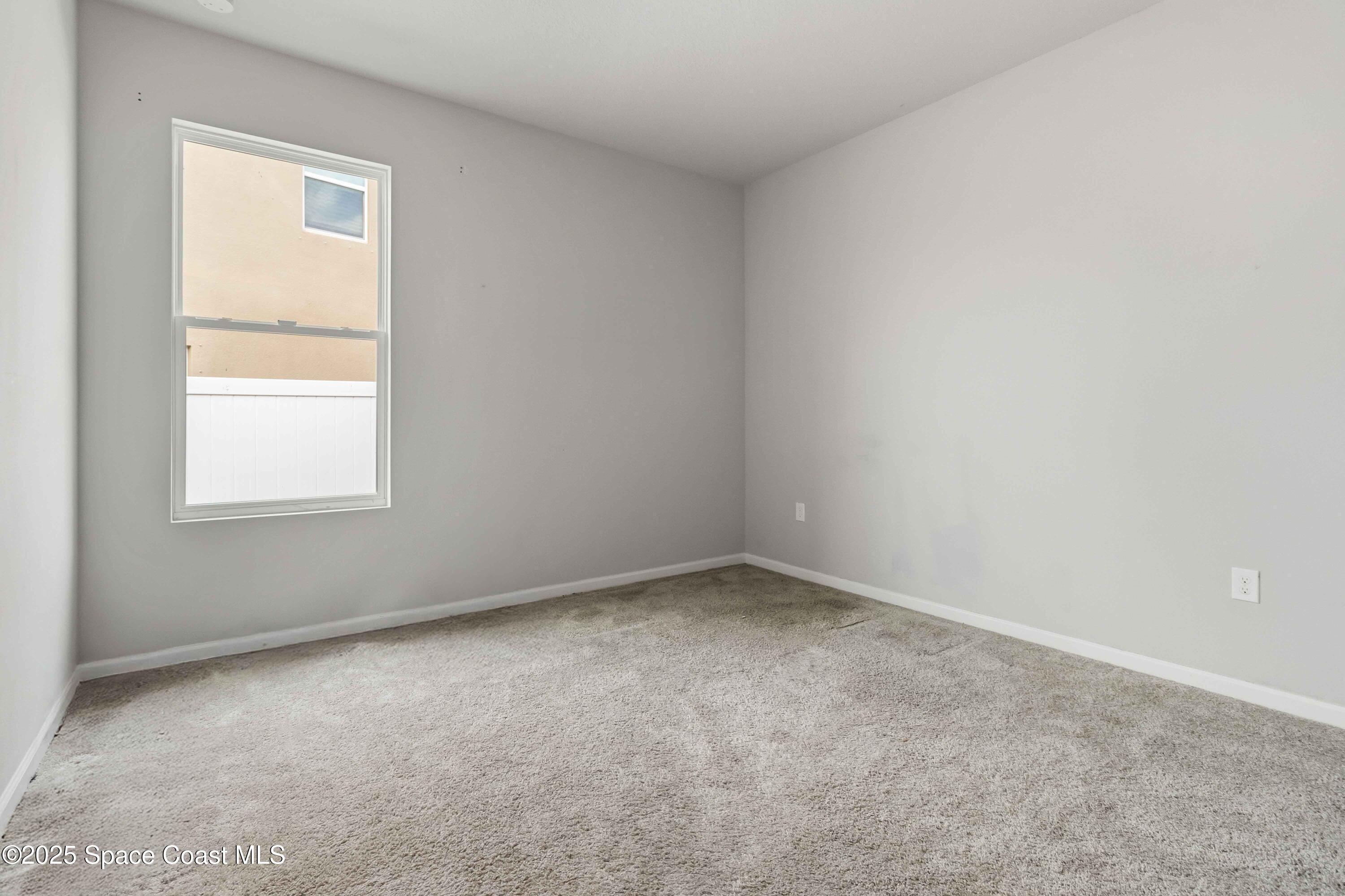 988 Corbin Circle Southwest Palm Bay, FL 32908 - Photo 18 of 26 an empty room with a window