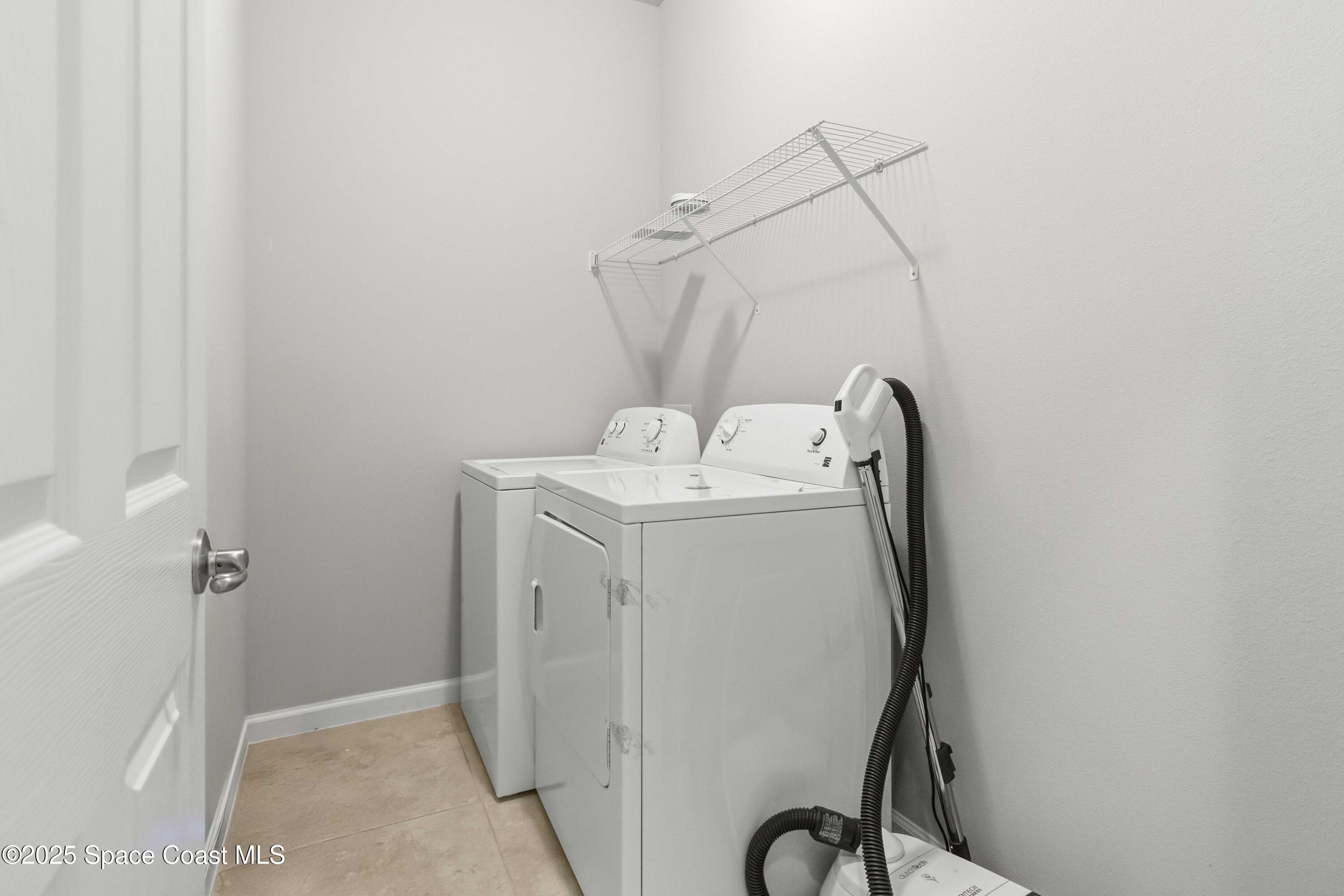 988 Corbin Circle Southwest Palm Bay, FL 32908 - Photo 20 of 26 a utility room with dryer and washer