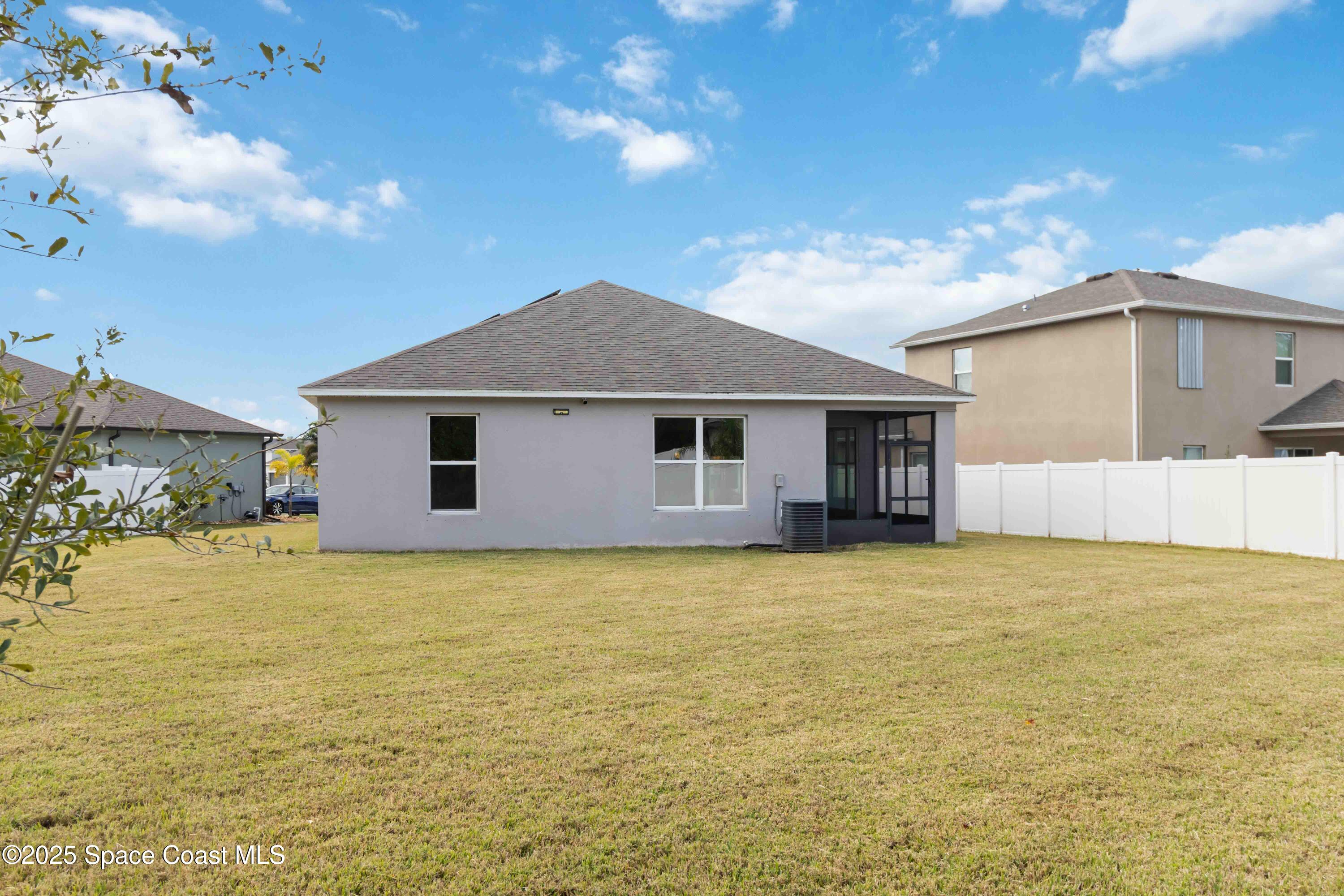 988 Corbin Circle Southwest Palm Bay, FL 32908 - Photo 23 of 26 a view of a house with a yard