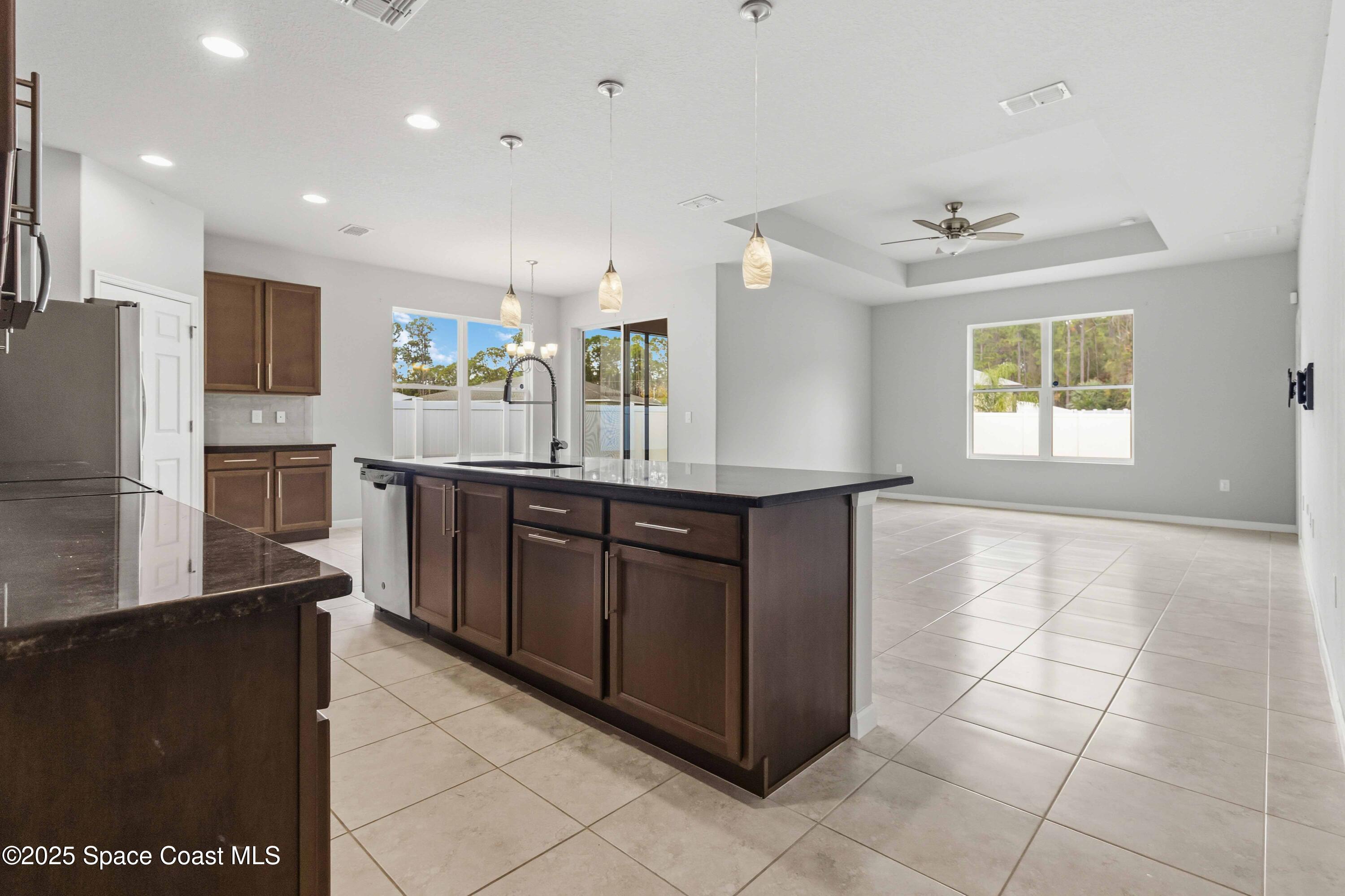 988 Corbin Circle Southwest Palm Bay, FL 32908 - Photo 4 of 26 a kitchen with stainless steel appliances granite countertop a refrigerator and a stove
