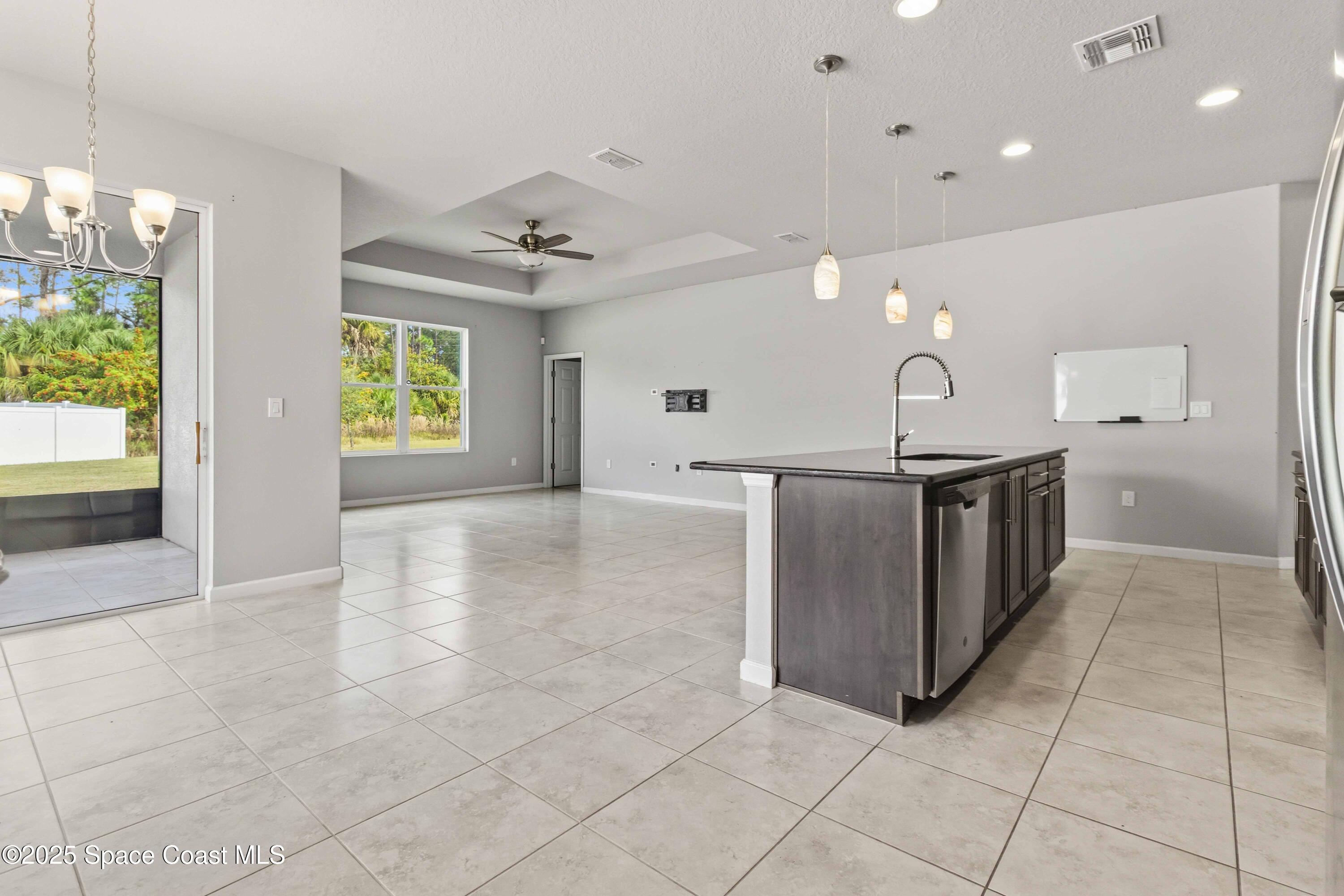 988 Corbin Circle Southwest Palm Bay, FL 32908 - Photo 25 of 26 a kitchen with stainless steel appliances a sink stove and cabinets