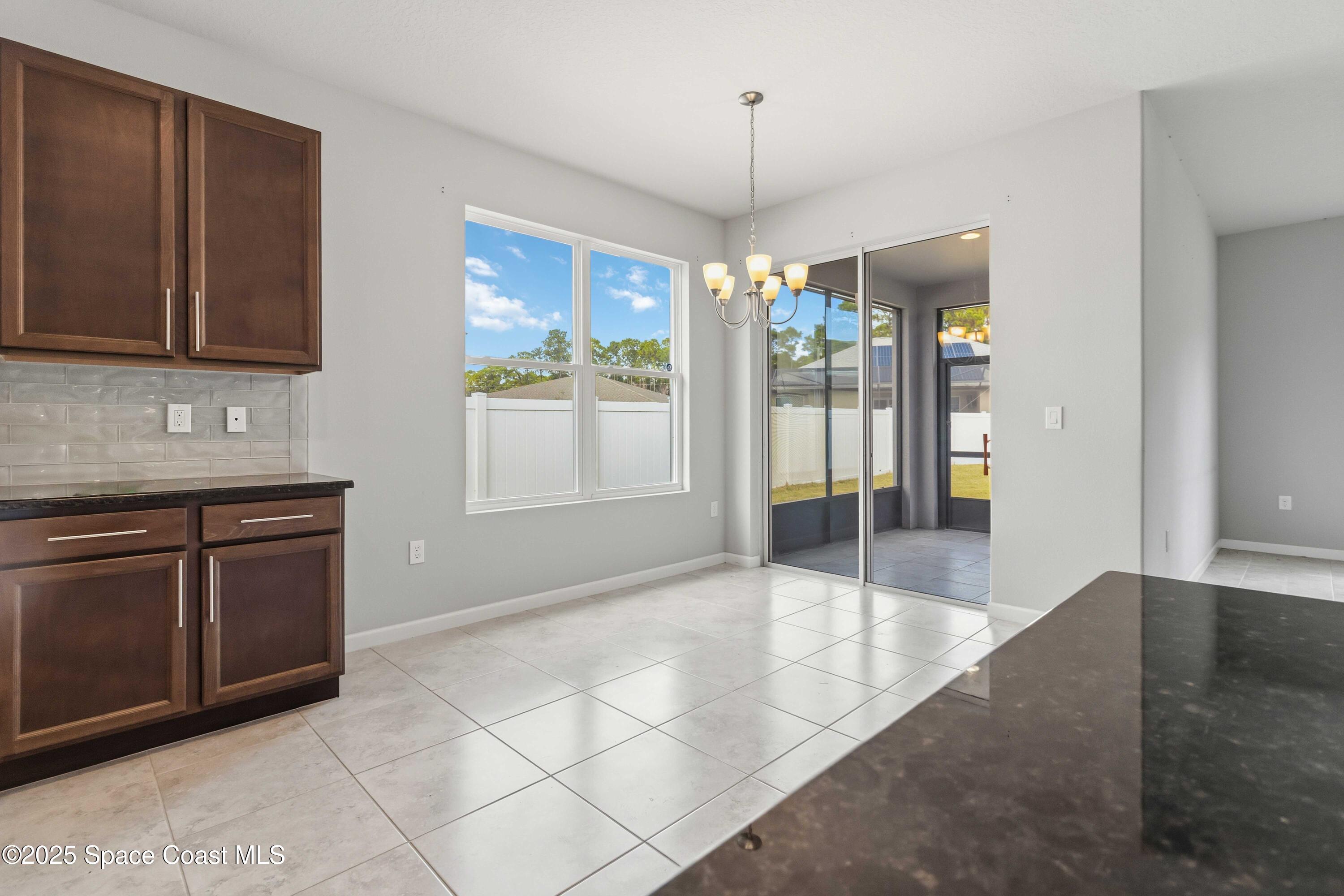 988 Corbin Circle Southwest Palm Bay, FL 32908 - Photo 6 of 26 a open kitchen with stainless steel appliances granite countertop a refrigerator and a sink