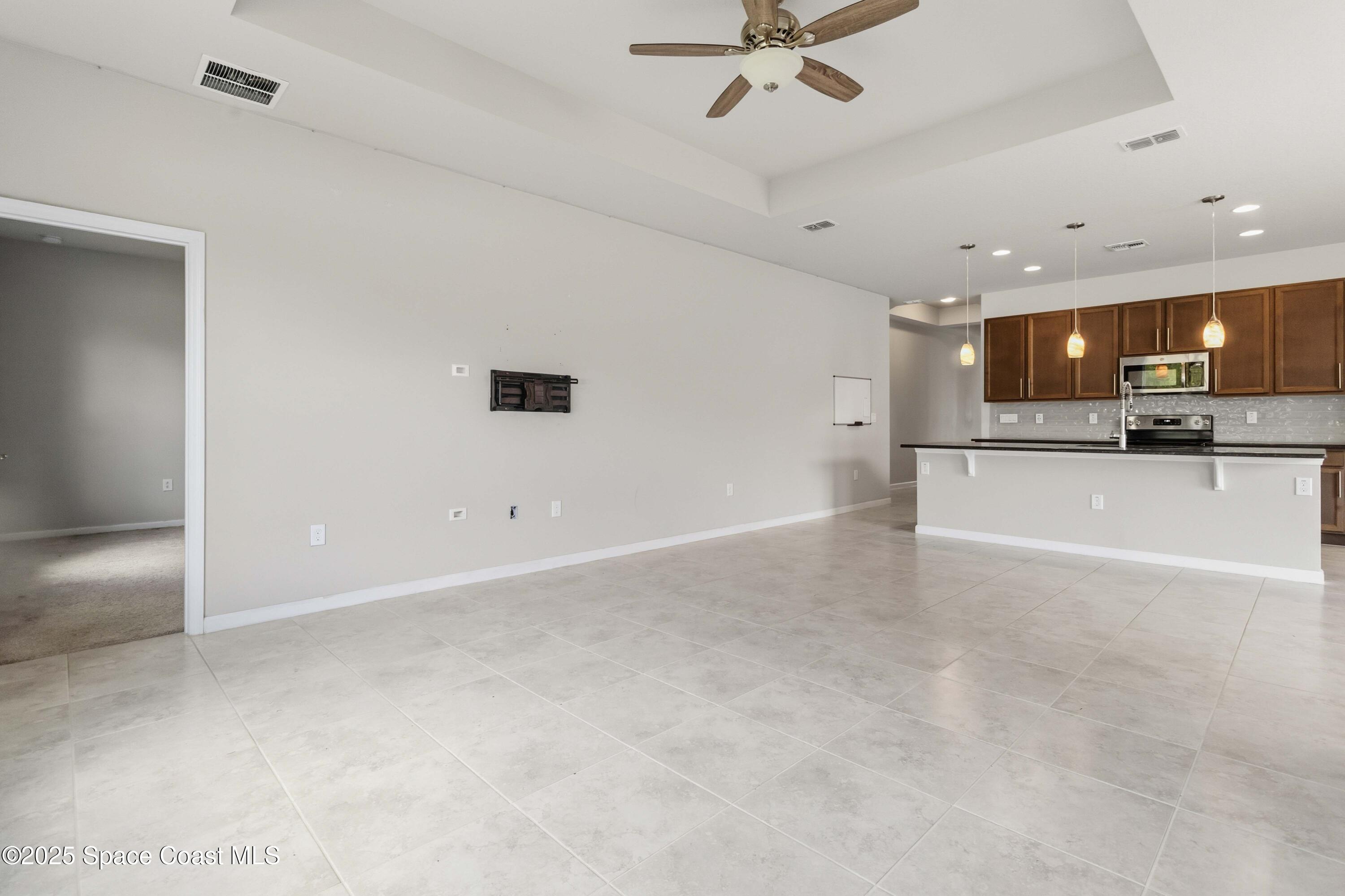 988 Corbin Circle Southwest Palm Bay, FL 32908 - Photo 7 of 26 a view of a livingroom and a kitchen with a sink
