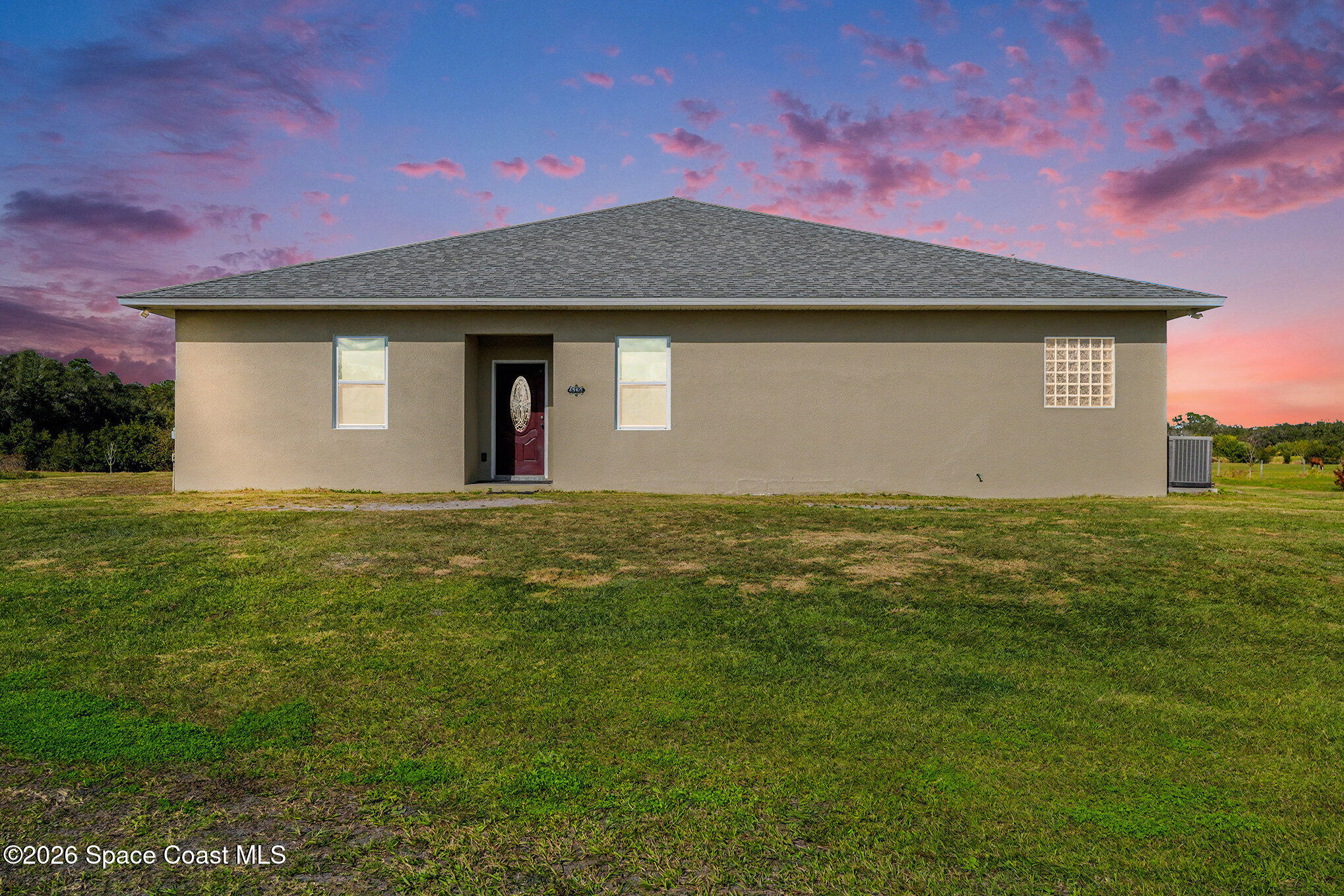 a front view of a house with yard