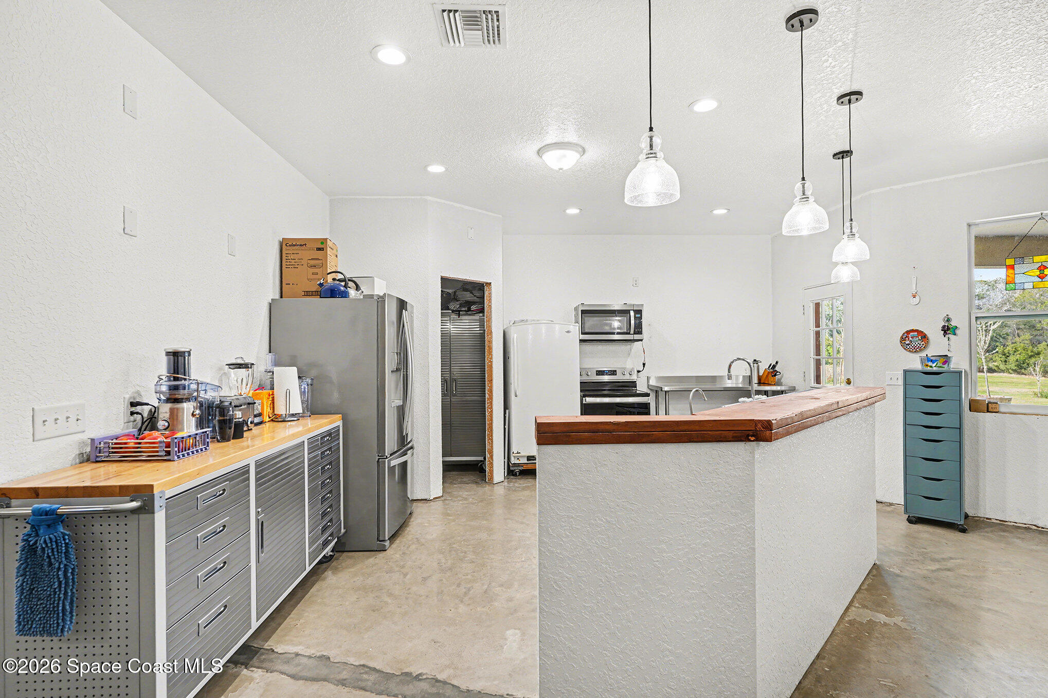 4960 Dixie Way Mims, FL 32754 - Photo 14 of 29 a kitchen with stainless steel appliances a stove sink and refrigerator